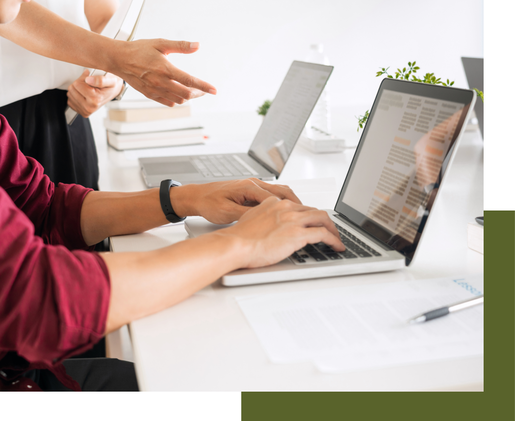 Two students working in a tutoring lab on their laptops