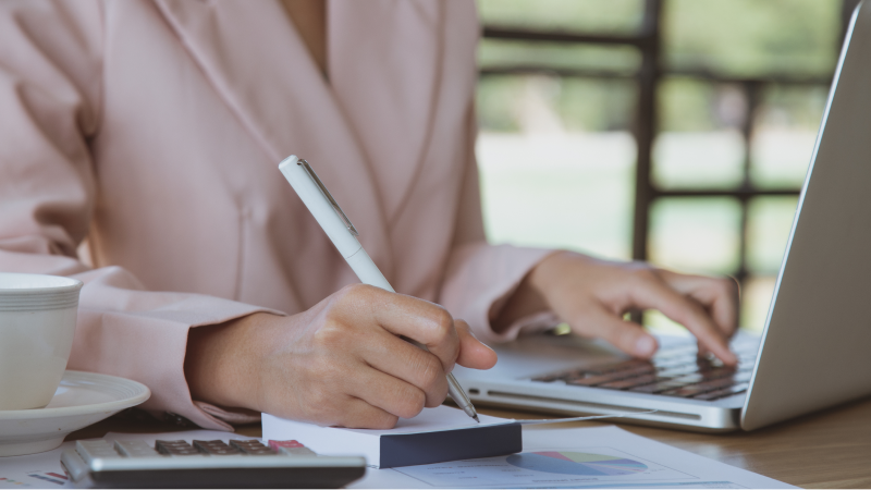 businesswoman working on laptop at her workstation
